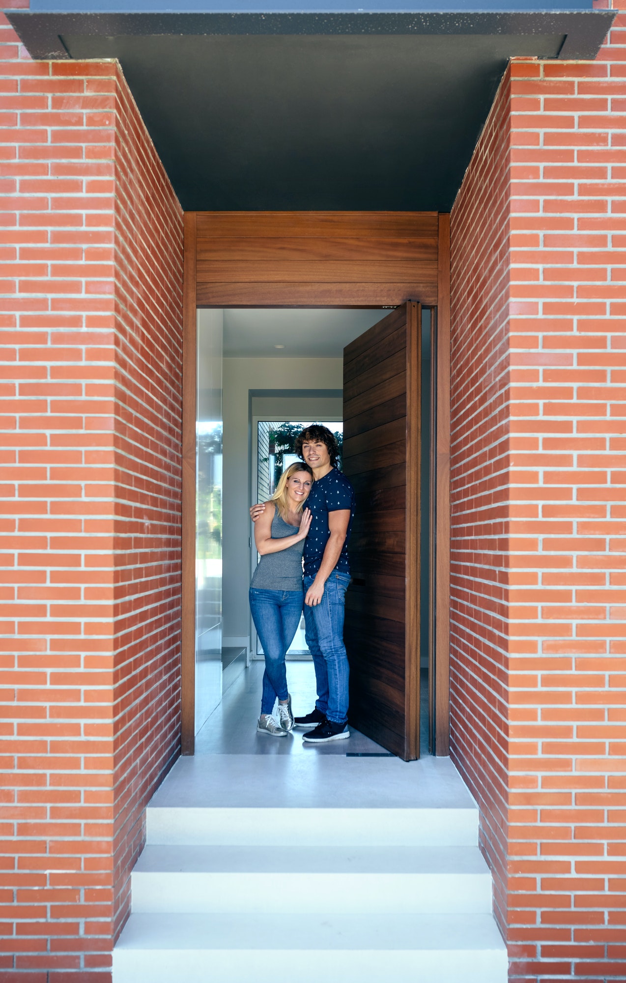 Couple at the entrance of their house